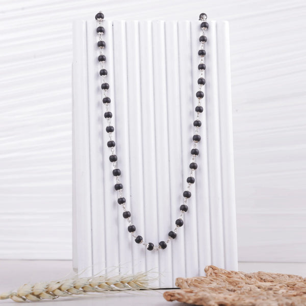 Original Karungali Malai on white display stand, natural ebony wood beads